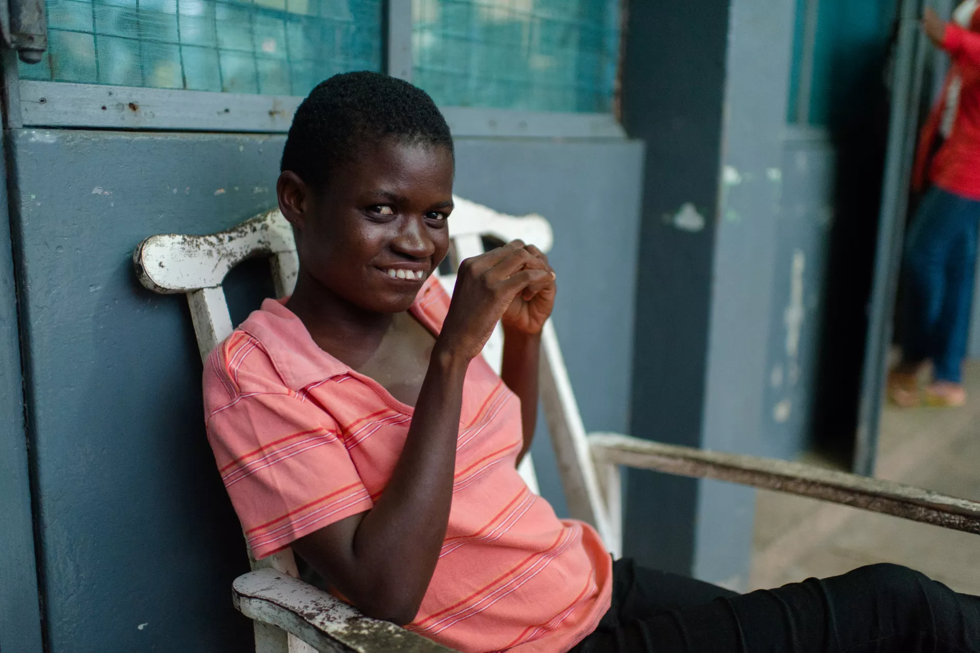 Florence, a child with special needs, sitting y herself outside a girls' common room at the Osu Children's Home in Accra, Ghana in 5 May 2015.