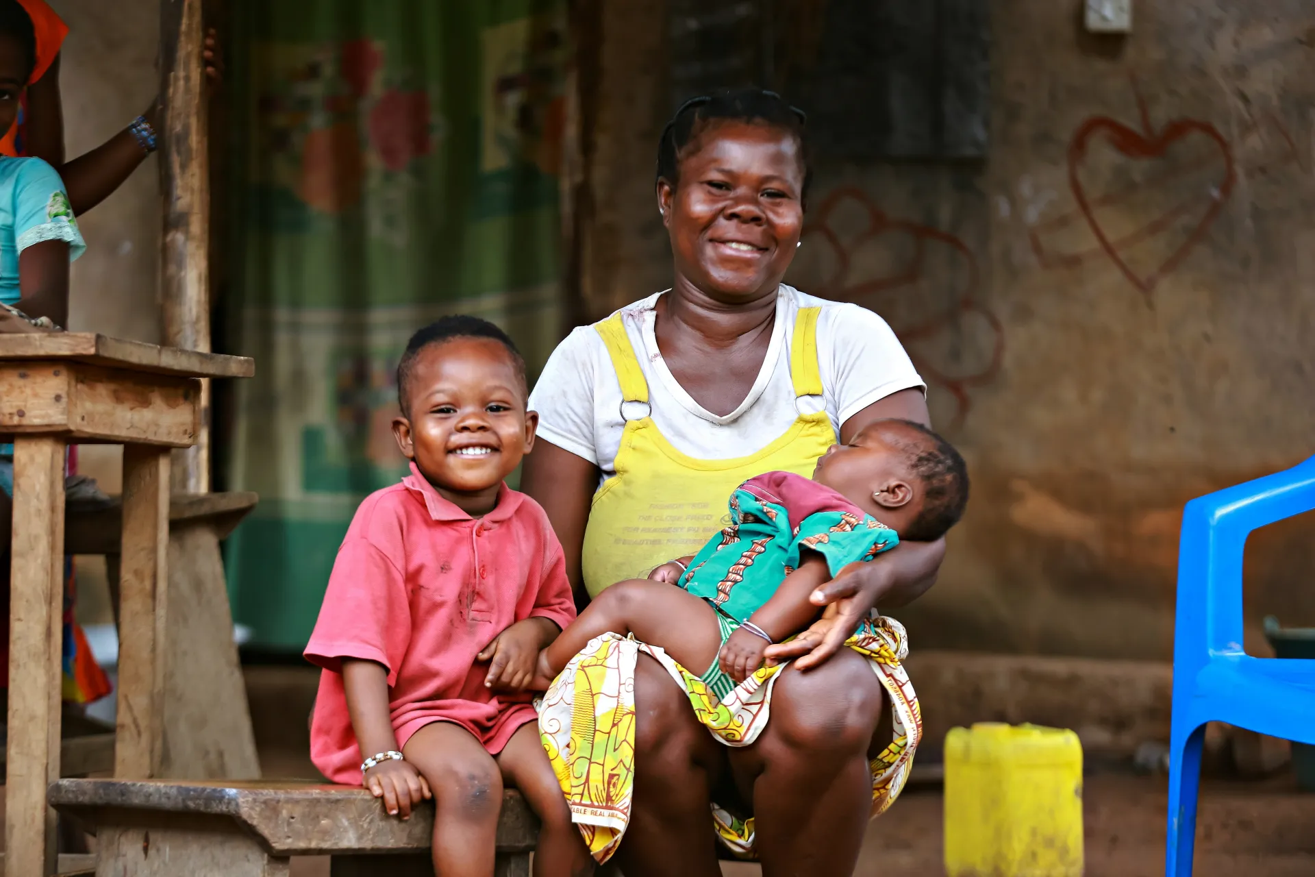 A mother with her two children at home