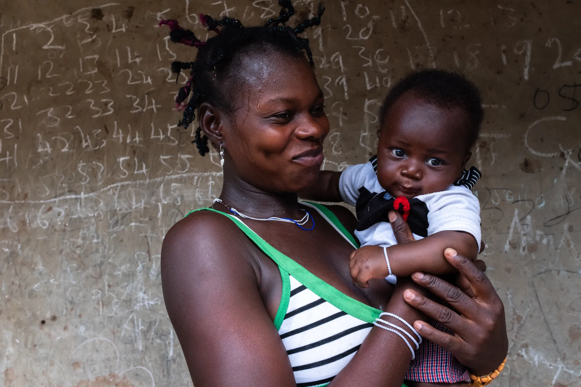 A woman smiles at her baby