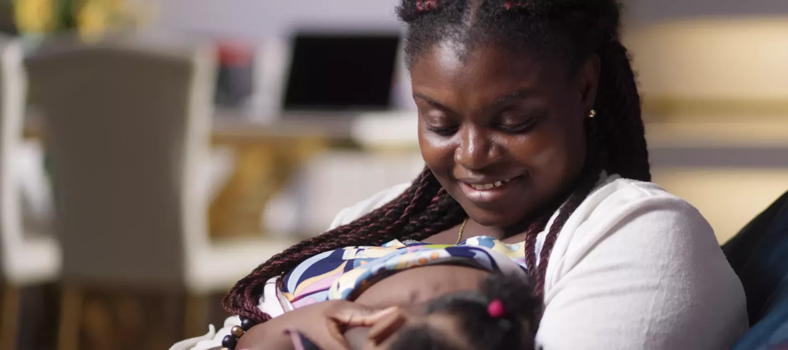 A mother breastfeeds the child.