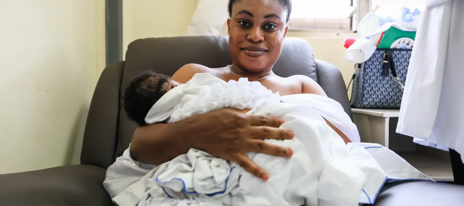 A woman holds her baby while breastfeeding. 