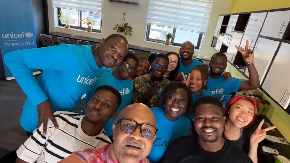 A selfie with former UNICEF Representative Mr. Osama Makawi and other young people, including Kenneth, at the office.