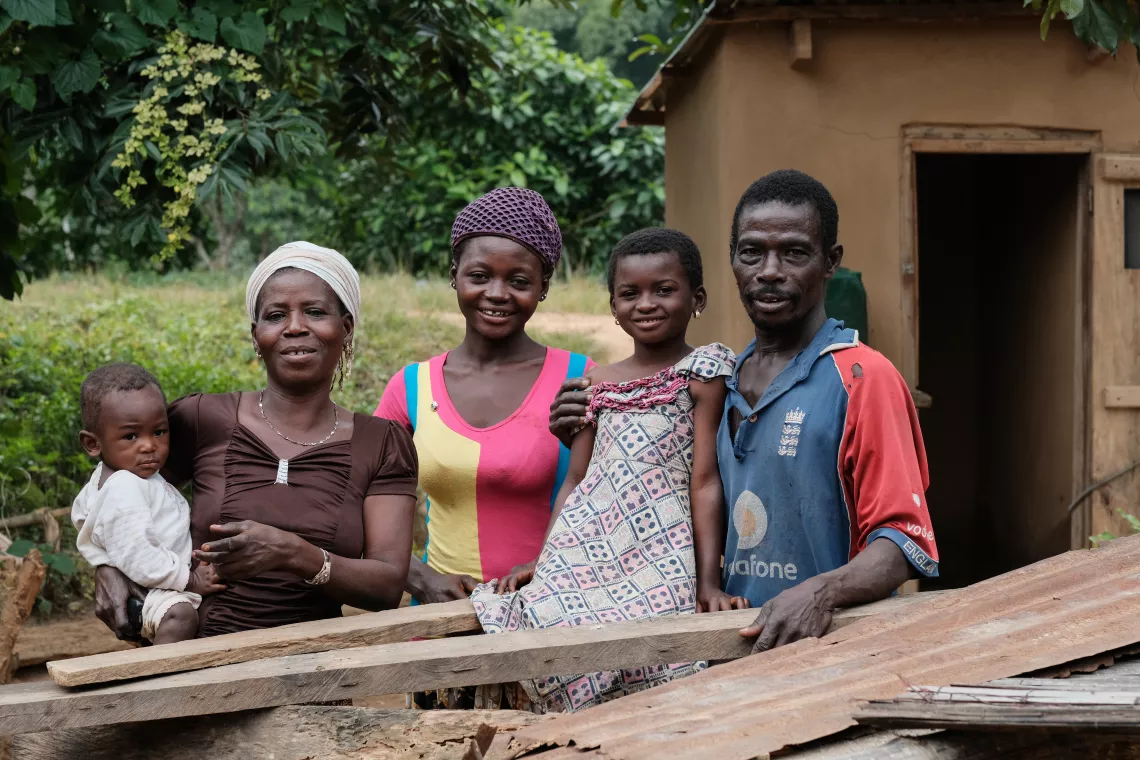 The Gbatgi family in front of their latrine in the open defecation free (ODF) community of Kassandgan.