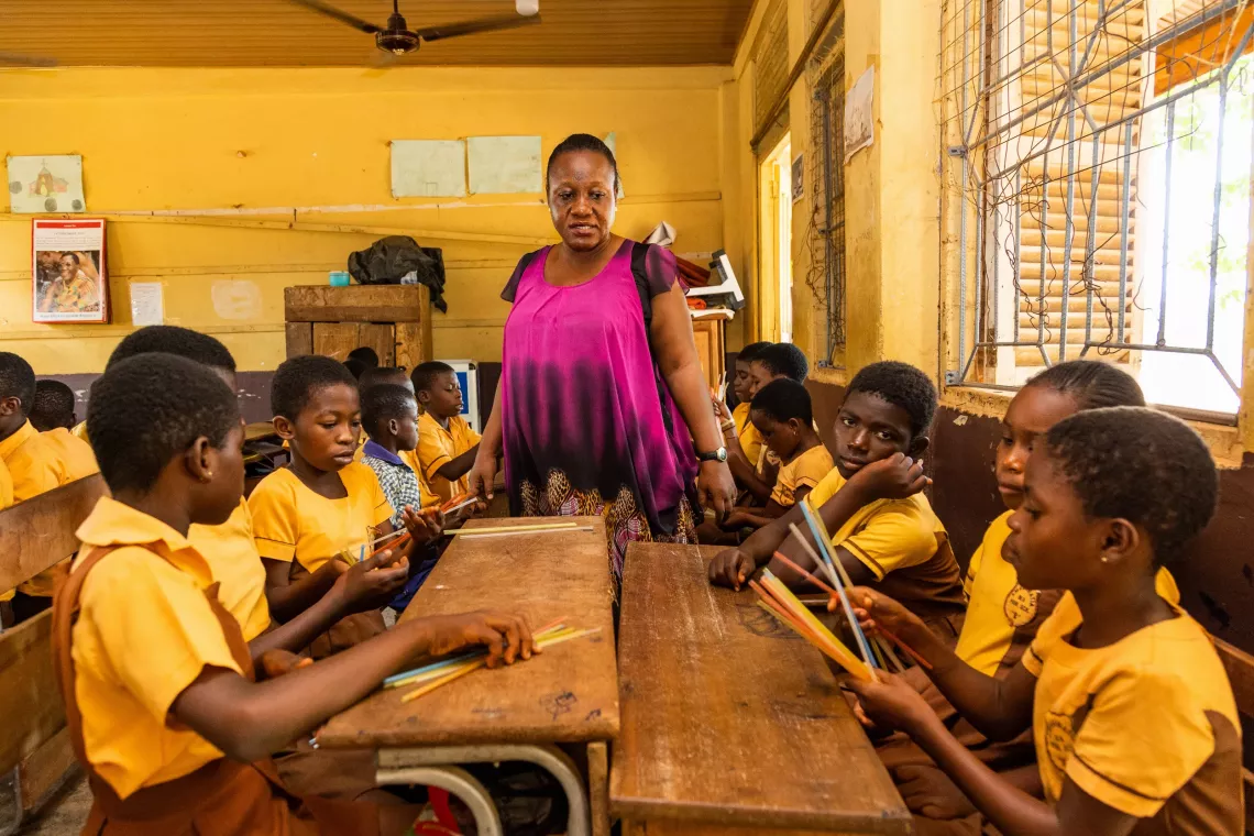 Children interacts among themselves to solve a math problem in the classroom.