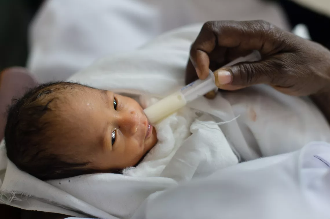 A baby being fed with a syringe at the Tamale Teaching Hospital in the Northern Region of Ghana on 24 September 2013.