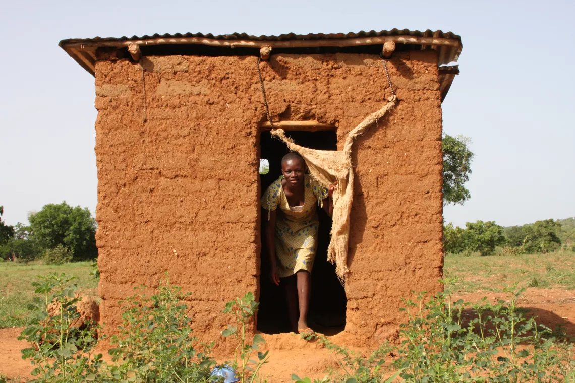Esther Dagawie (16) outside her latrine in Lambussie, Ghana.