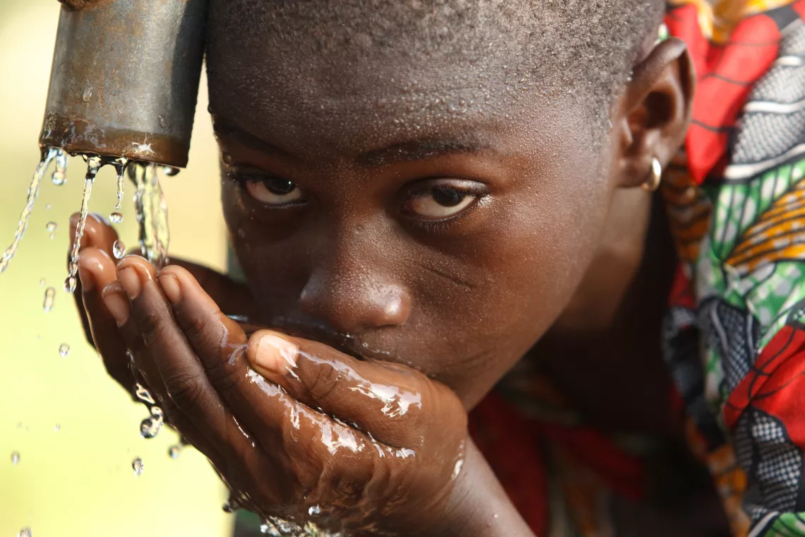 A girl drinks from a hand pump in the village of Moglaa, Ghana on Thursday November 11, 2010.