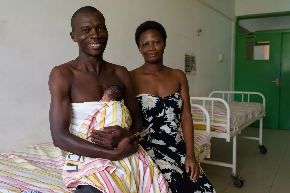 Phillip and Gloria Baawuo with their as yet unnamed son (traditionally children are not named until their seventh day) at the Bolgatanga Regional Hospital in the Upper East region of Ghana. They are using kangaroo mothercare - or in this case, fathercare! - a low-tech approach to keeping premature babies warm, to keep their son warm without the need for an incubator.  This simple technique has been responsible for greatly improving the survival rate of low-birthweight babies.