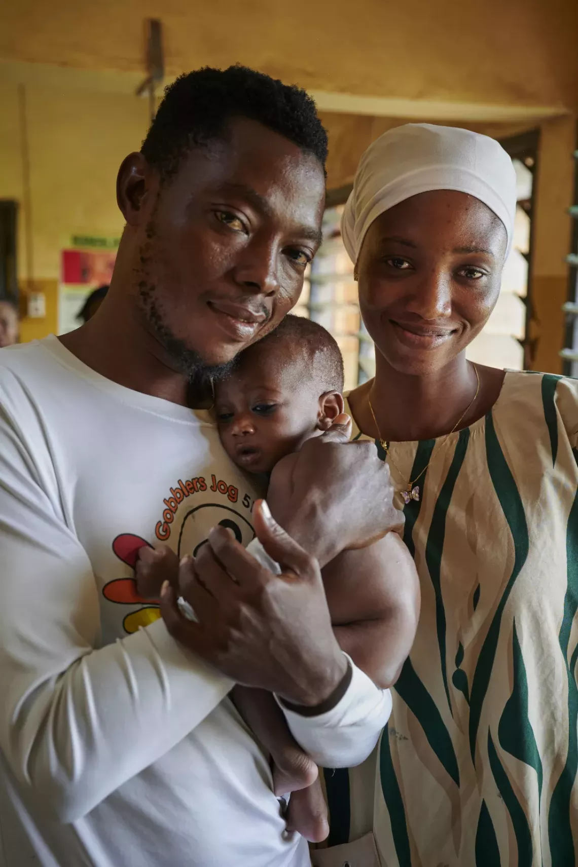 Yussif & Salma hold Hilder as they arrive at the weighing center.