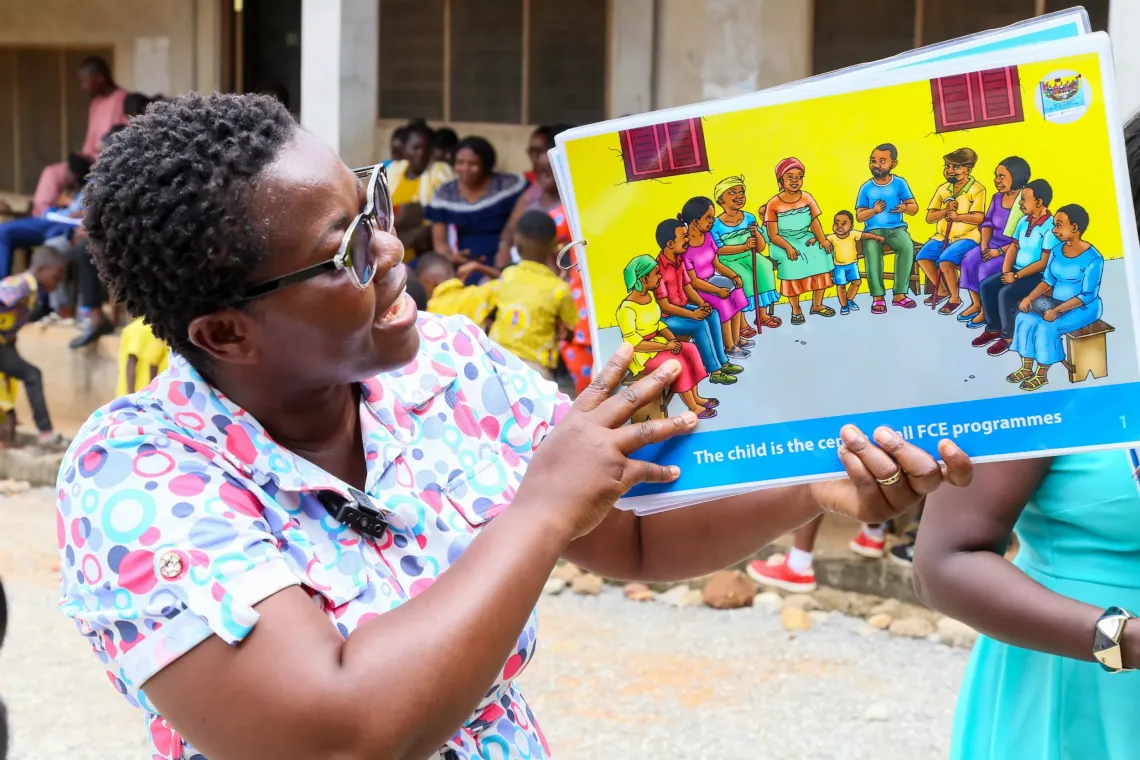 A teacher displays a pictorial view of child-family engagement.