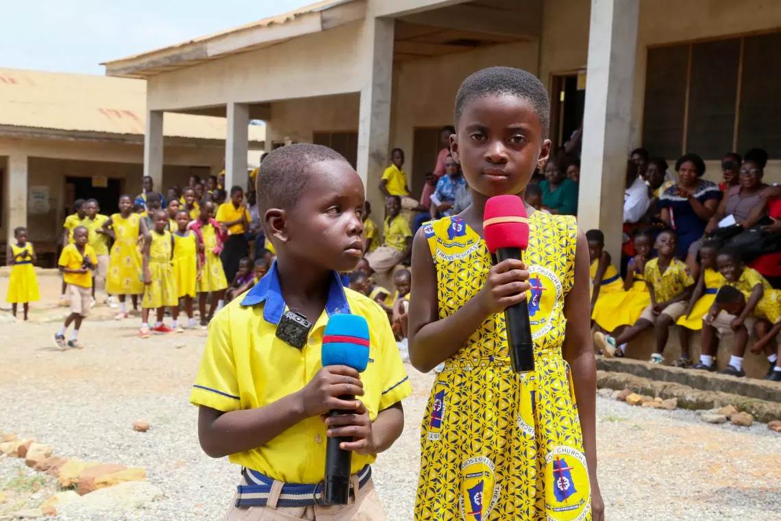 A boy and girl share a message with the Bomfah community.
