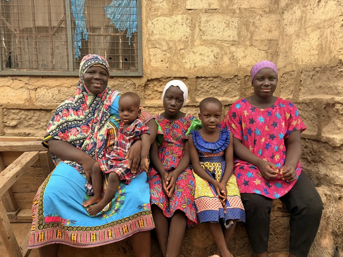 Abdul Warris-Fatma, 45, sits in front of her home with her four children: Umuhaira, 15, Abidat, 12, Aqeedat, 8, and Samantha, 1. 