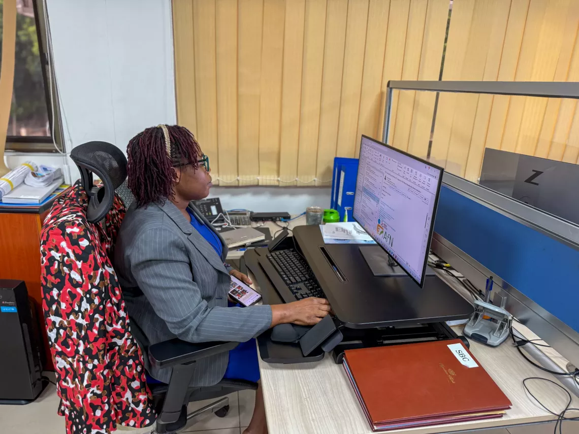 Miriam is working on her computer during a typical workday.