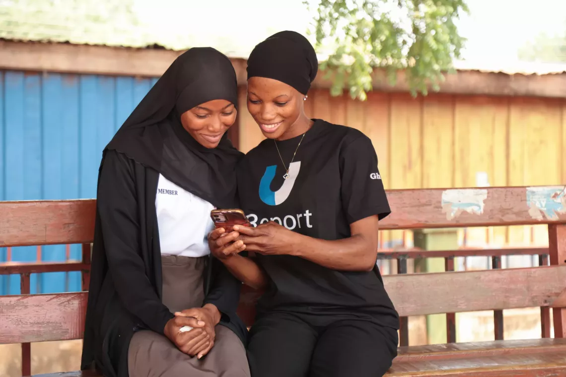 U-Reporter engages a young person in a poll with a smile.