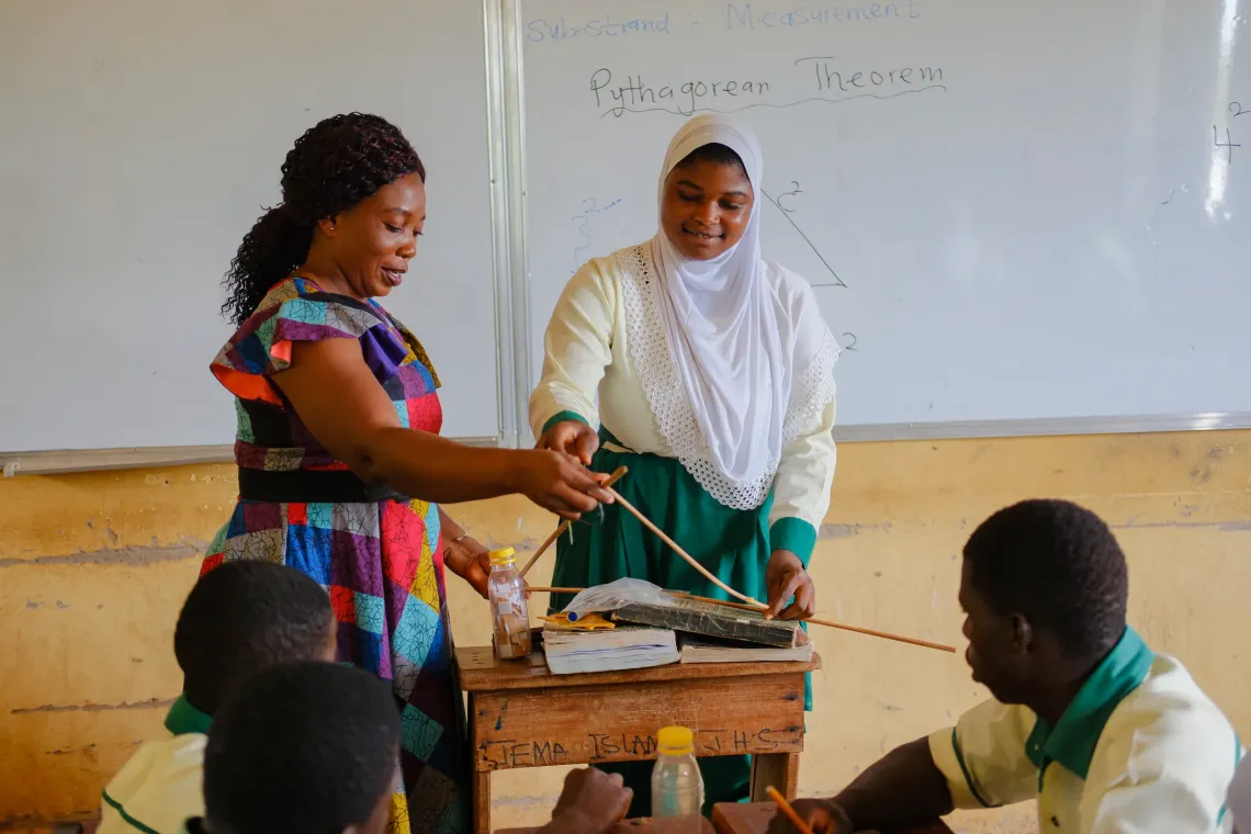 Maria enegees with  Angela  a student during class 