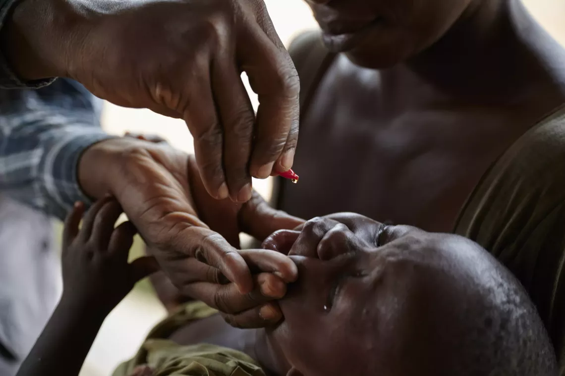 Health Worker gives high potency Vitamin A dose to Justice. 