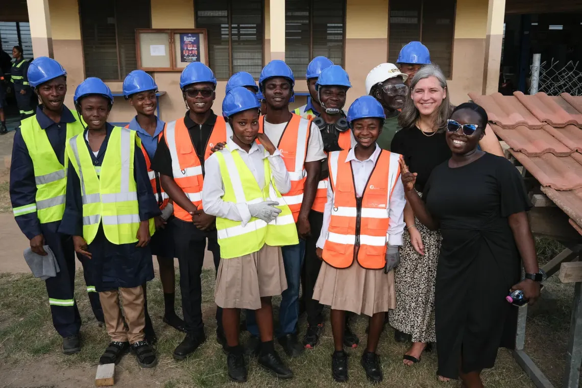 Christin Lucille McConnell, Chief Education, UNICEF Ghana, Grace Akua Gyan-Darkwa, an Adolescent and Youth Officer, poses for a photo with students during a tour of facilities at the Applied Technology Institute in Accra