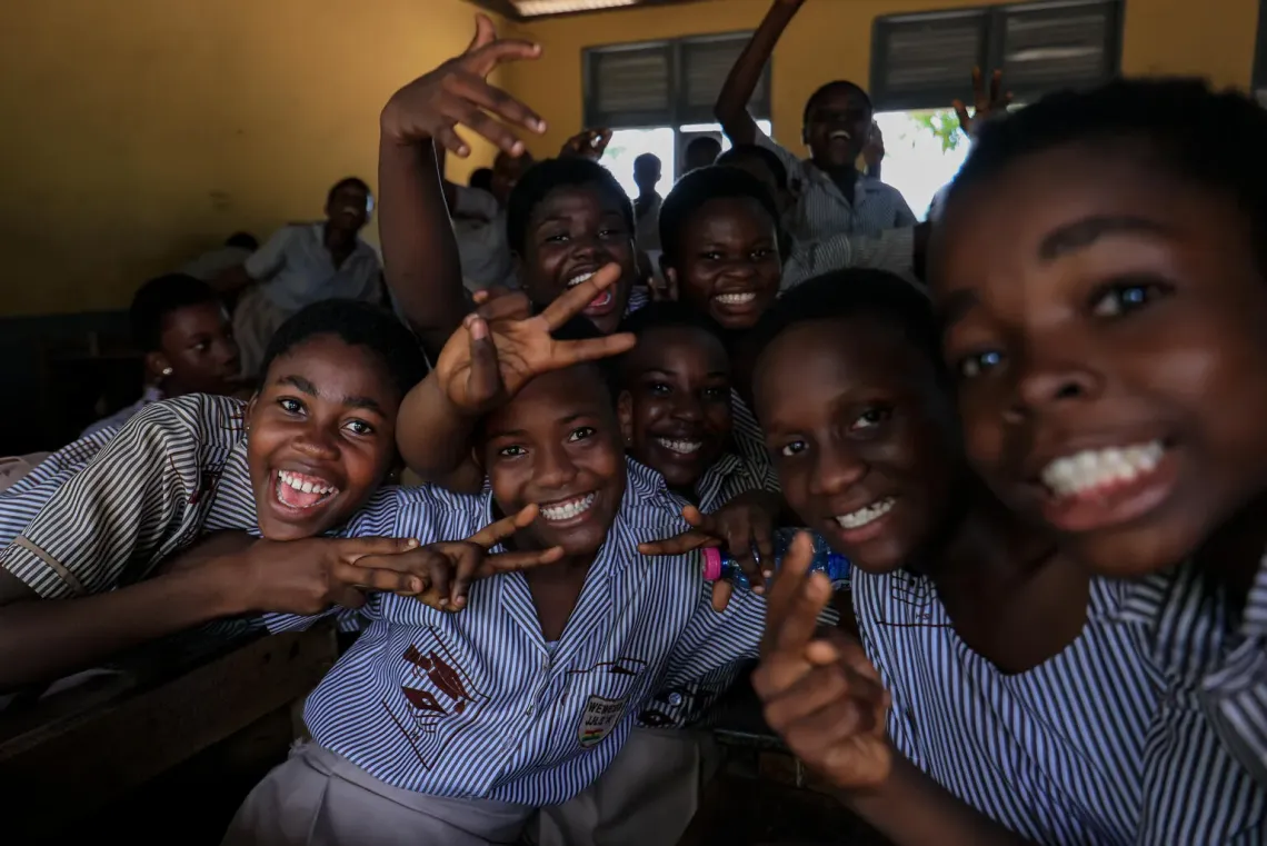 Happy school children in a classroom.