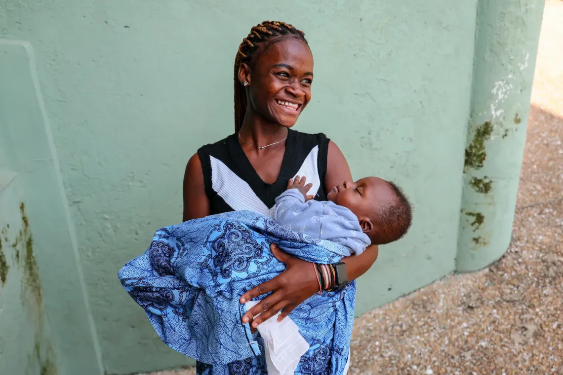 Elizabeth Darko, 18, a student, carries her 7-month-old baby while attending an adolescent parenting school at Kumasi South Hospital in the Ashanti Region, Ghana.