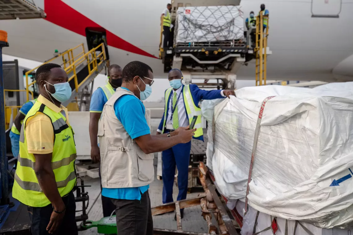 UNICEF staff checking supplies from an airplane at Kotoka International Airport.