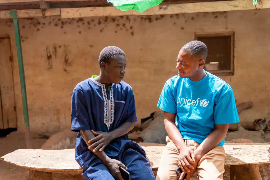 Haruna speaks with Unicef team member during the community engagement 
