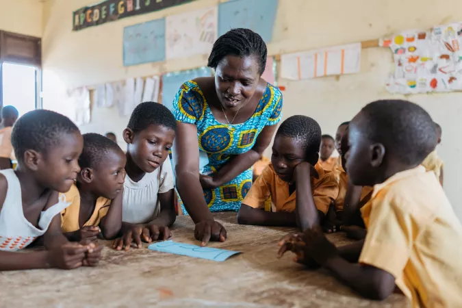 Teacher with group of children teaching in classroom