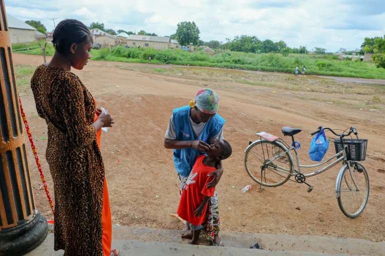 Community volunteer Yussif Khadija administers medication to a child during her home visit in Zini, Upper West Region of Ghana.