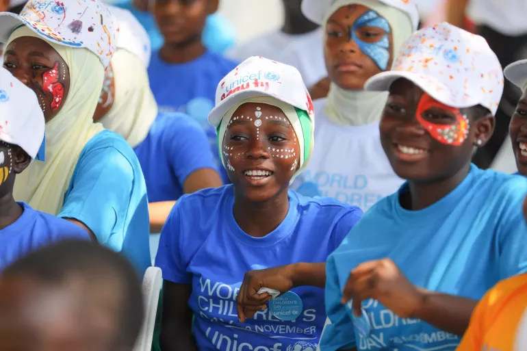 Children smile as they are spot a face painting.