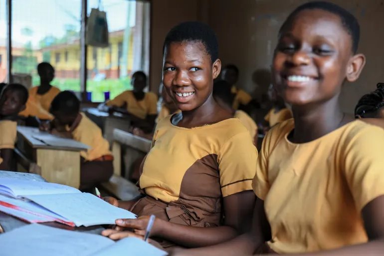 a photo of 2 girl students smilling 