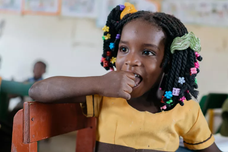 Little girl smiling in classroom