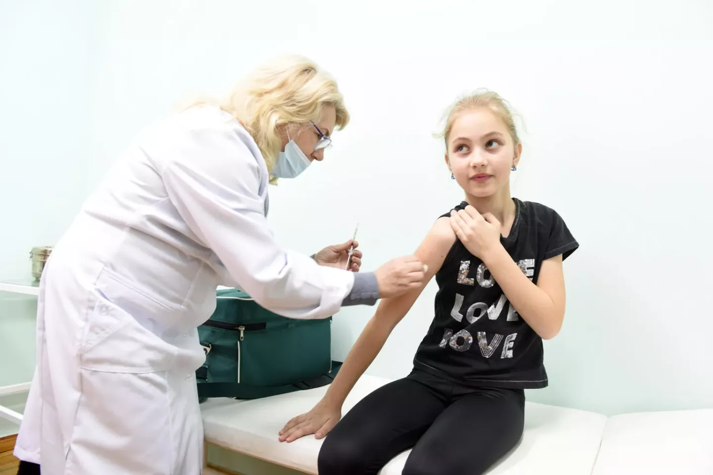 A girl  receives her first dose of MMR vaccine 