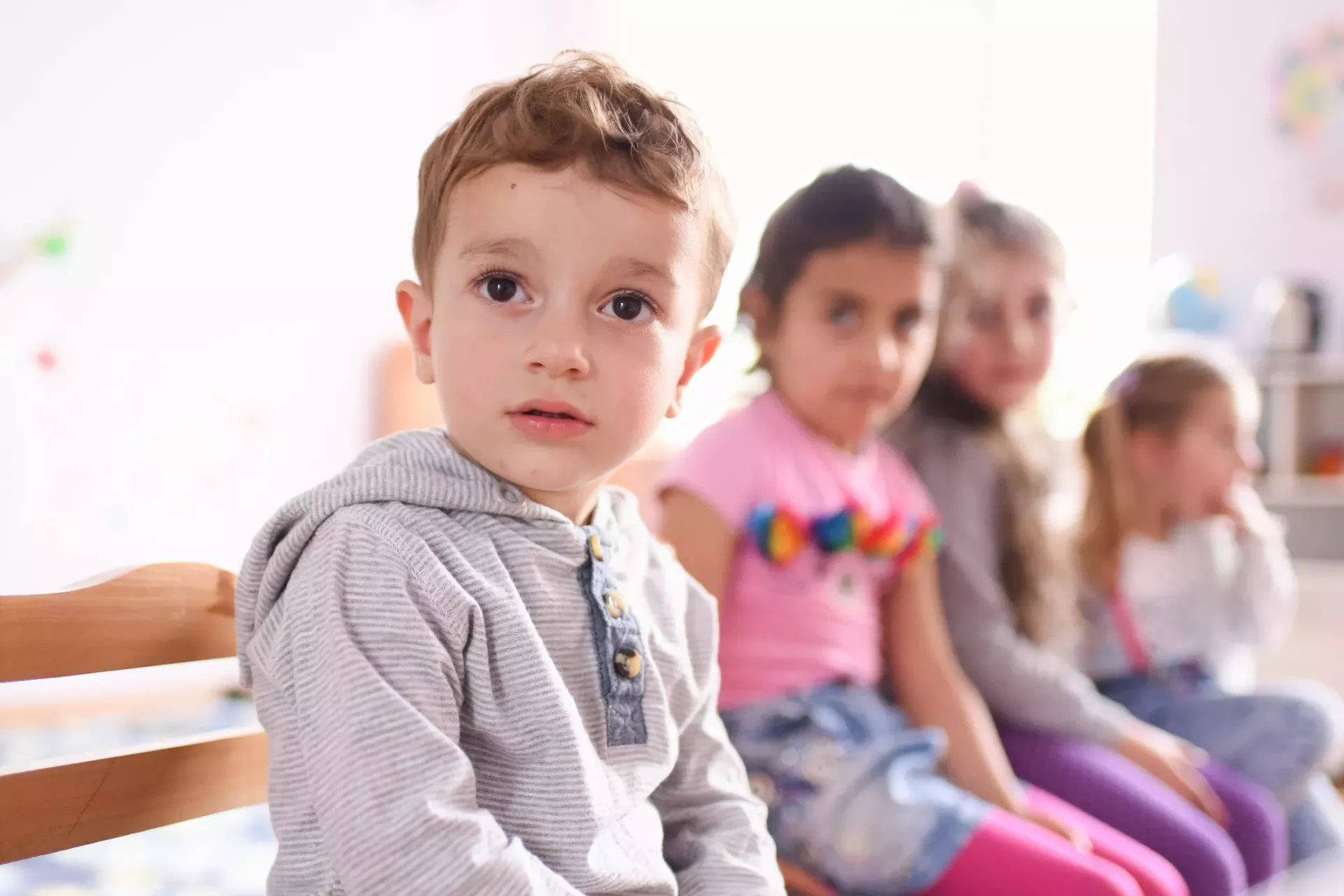 A group of children sitting on a chair
