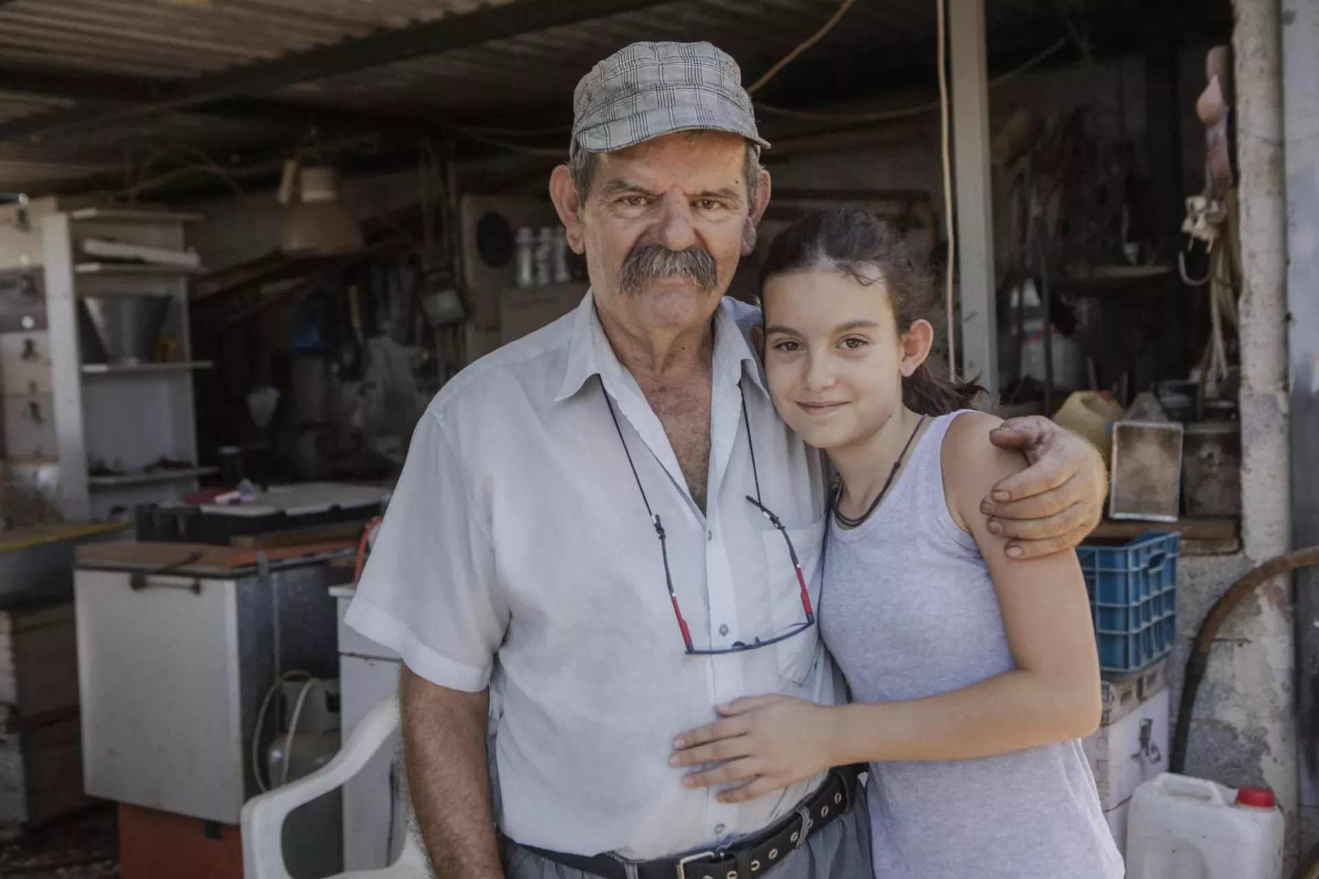 Markos Sarikostas, 70, a pensioner and a beekeeper from Nea Makri, Greece with his grand daughter, 11year old, Markela.