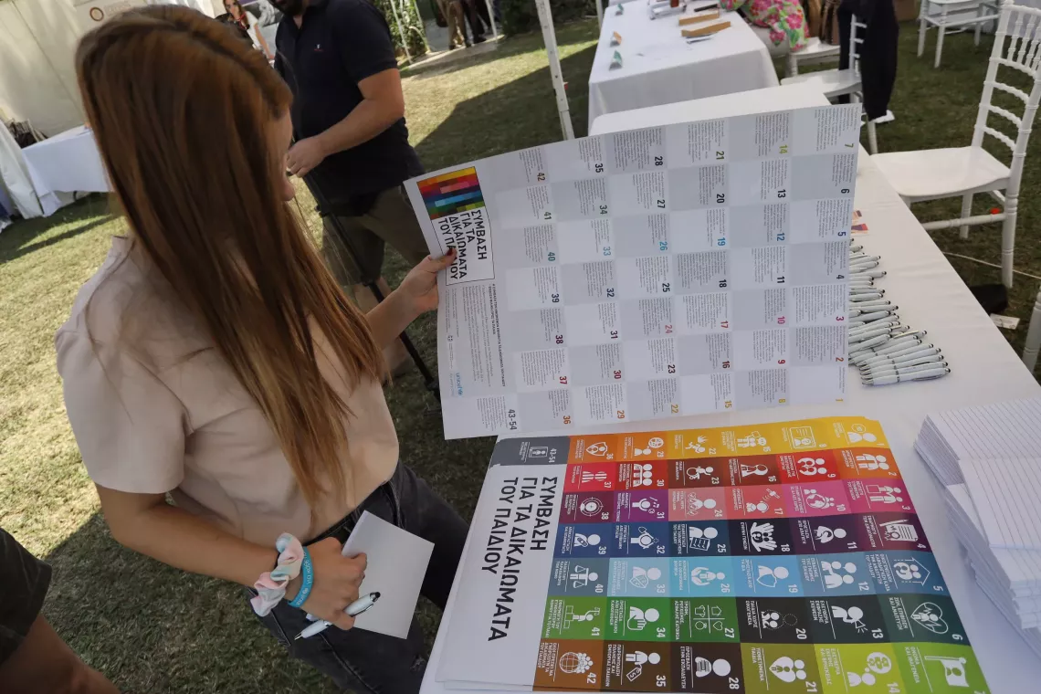 Girl reading through a UNICEF poster