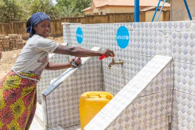 Fanta, a mother, uses a drinking water supply in Siguiri in the Kankan region of Guinea. 