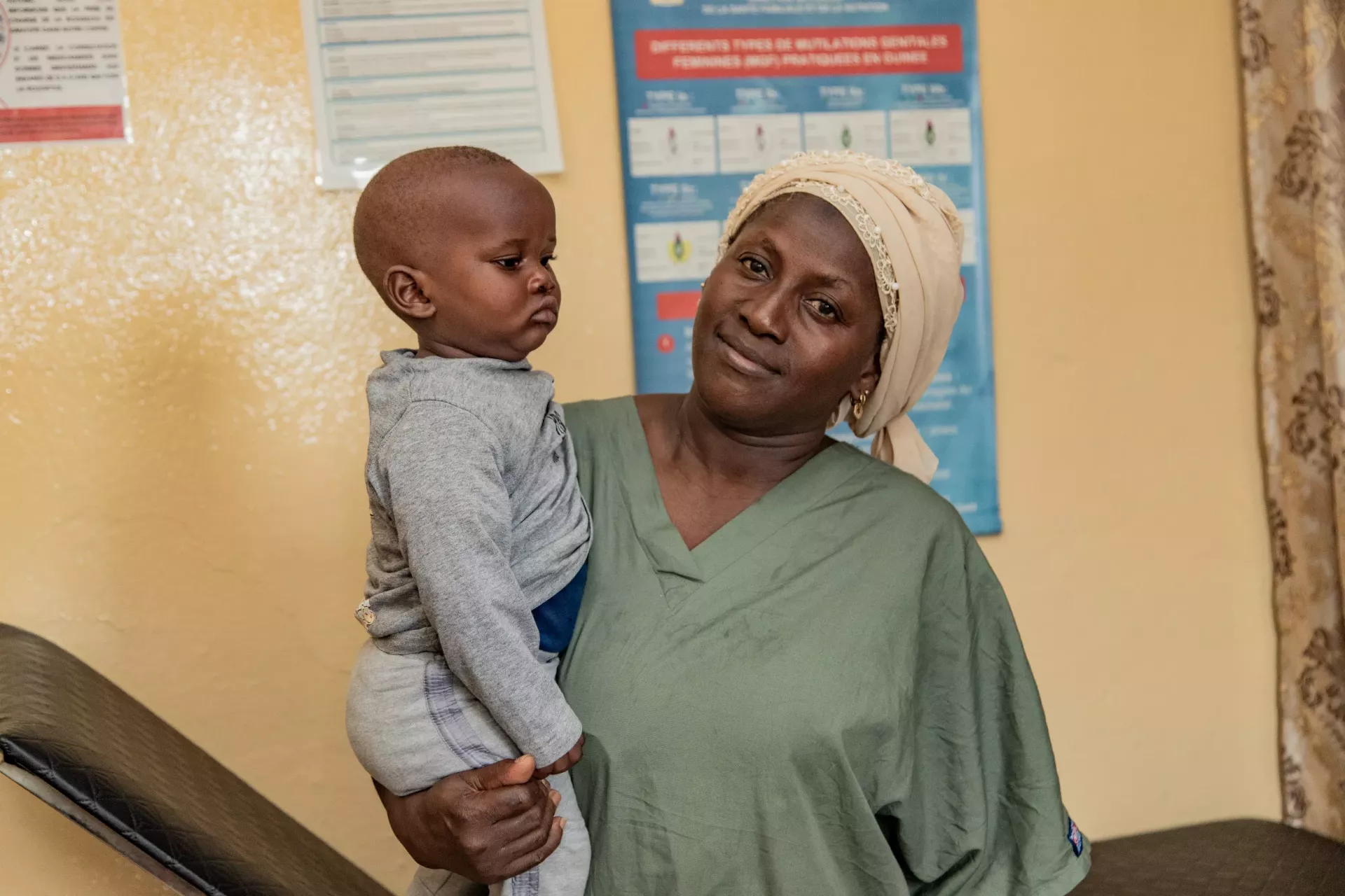 Damb&eacute;l&eacute; Aissata, nurse, and Mohamed, 9 months. Bernay-Fotoba health centre in the commune of Matoto in Conakry, Guinea.