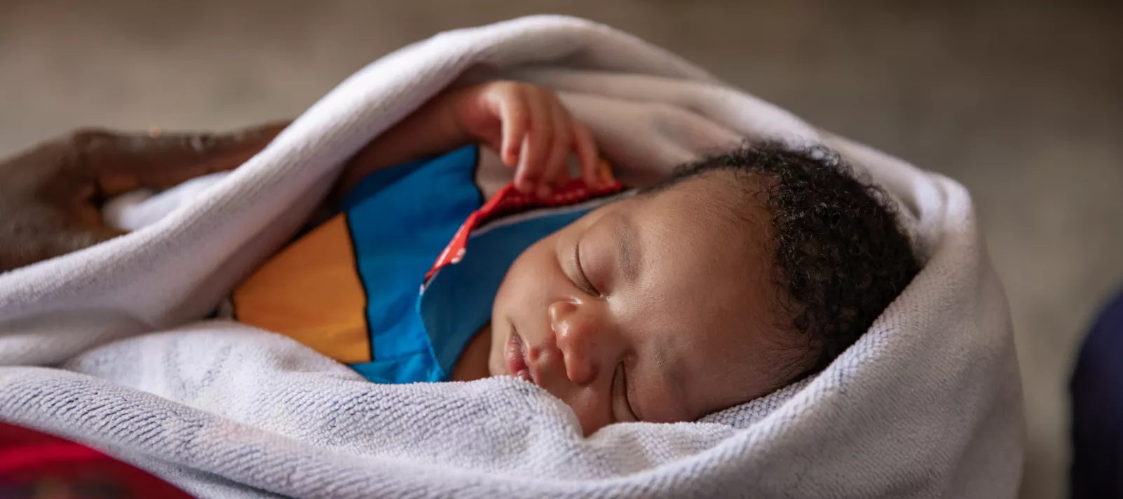 Pépé, 1 week old, born in the health center of the convergence commune of Kobéla, in the arms of his mother, Nzérékoré region in Guinea. 