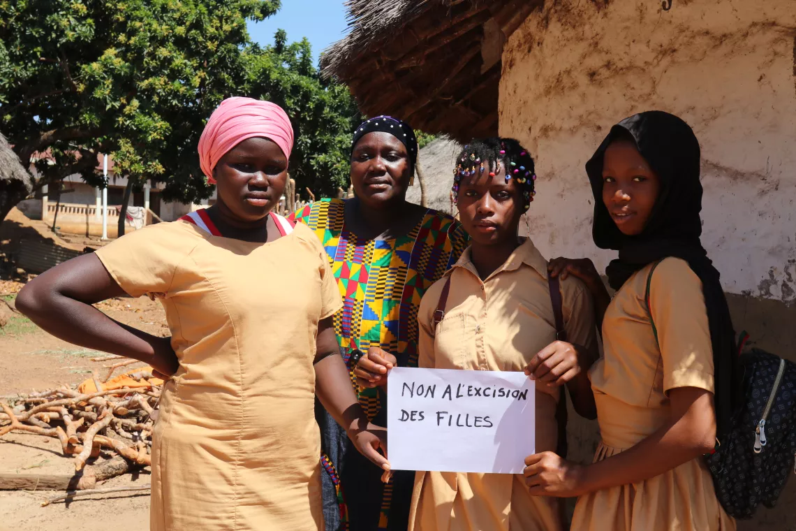 Koulako, surrounded by her three daughters, fights against female genital mutilation. Damaro, Kankan region, Guinea.