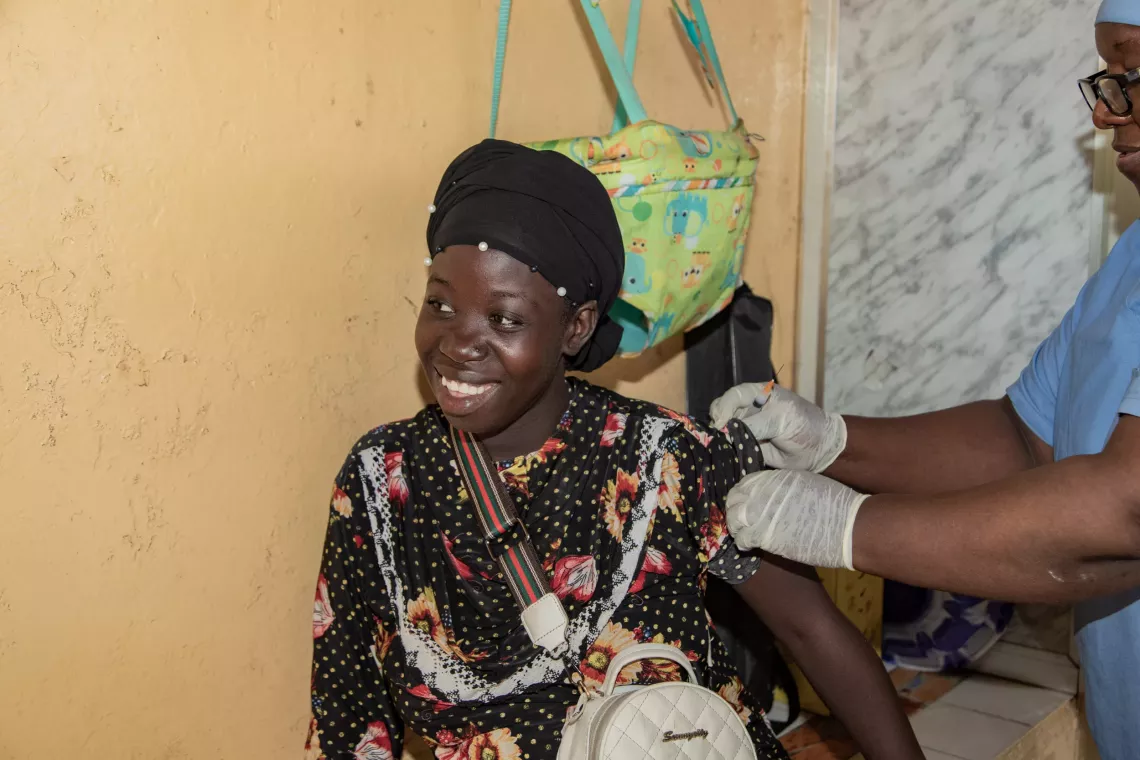 Djenn&eacute; Kaba, a mother of one, pregnant with her second child, is vaccinated by Sambou Bayo, a vaccinator with the Expanded Programme on Immunisation. Bernay-Fotoba health centre in the Matoto commune of Conakry, Guinea.