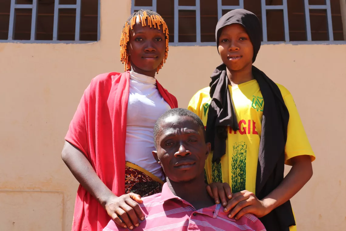Nantenin, her sister and their father, Damaro commune, Kankan region, Guinea.