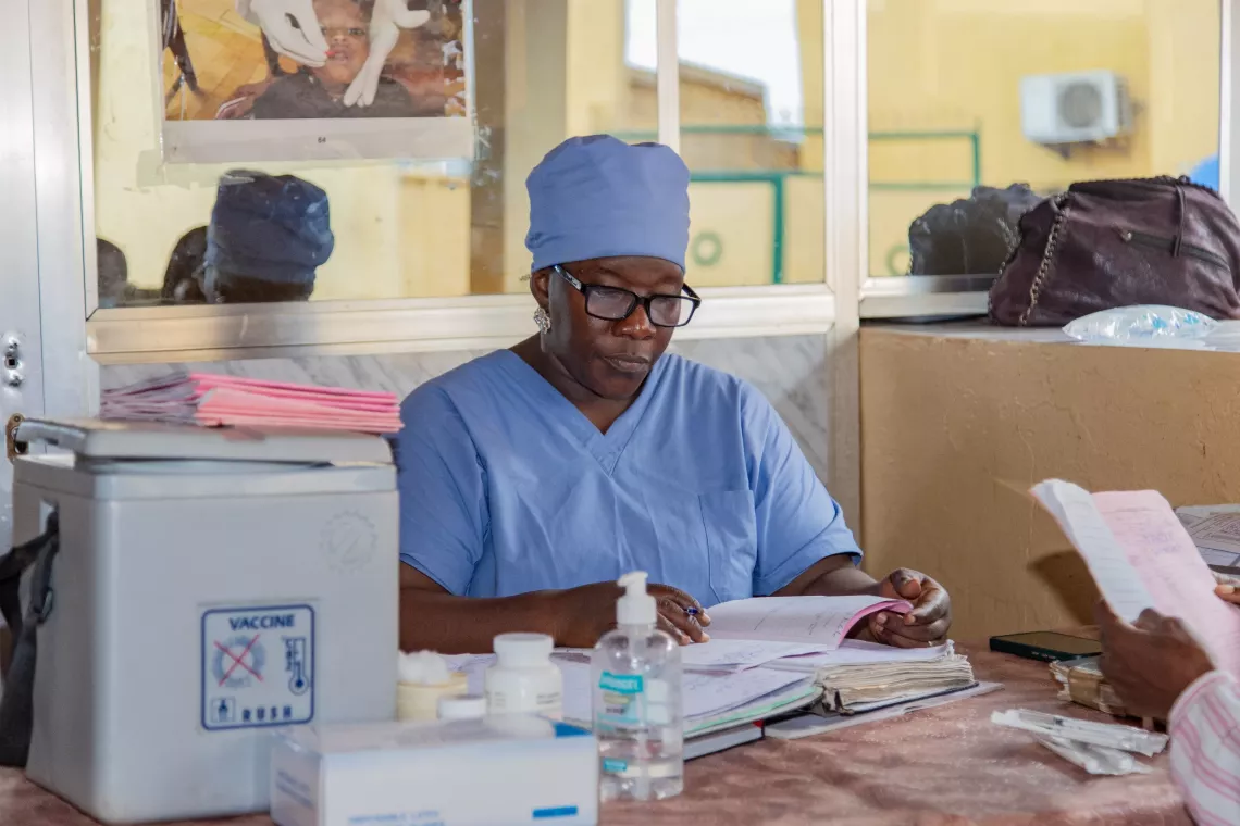 Sambou Bayo, vaccinator for the Expanded Programme on Immunisation. Bernay-Fotoba health centre in the Matoto commune of Conakry, Guinea.