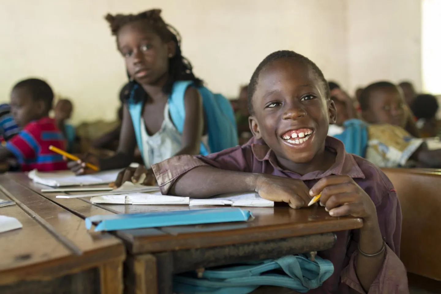 Boy with motor disability smiles in class