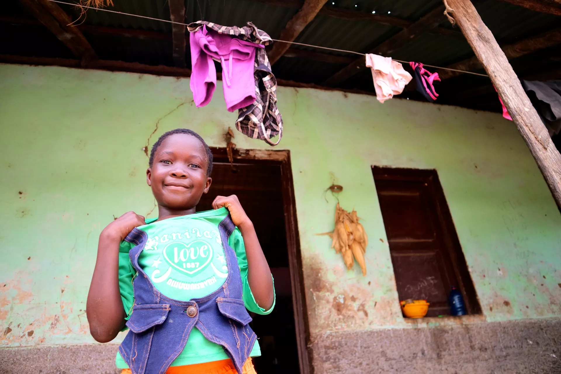 Girl standing at the entrance of her house
