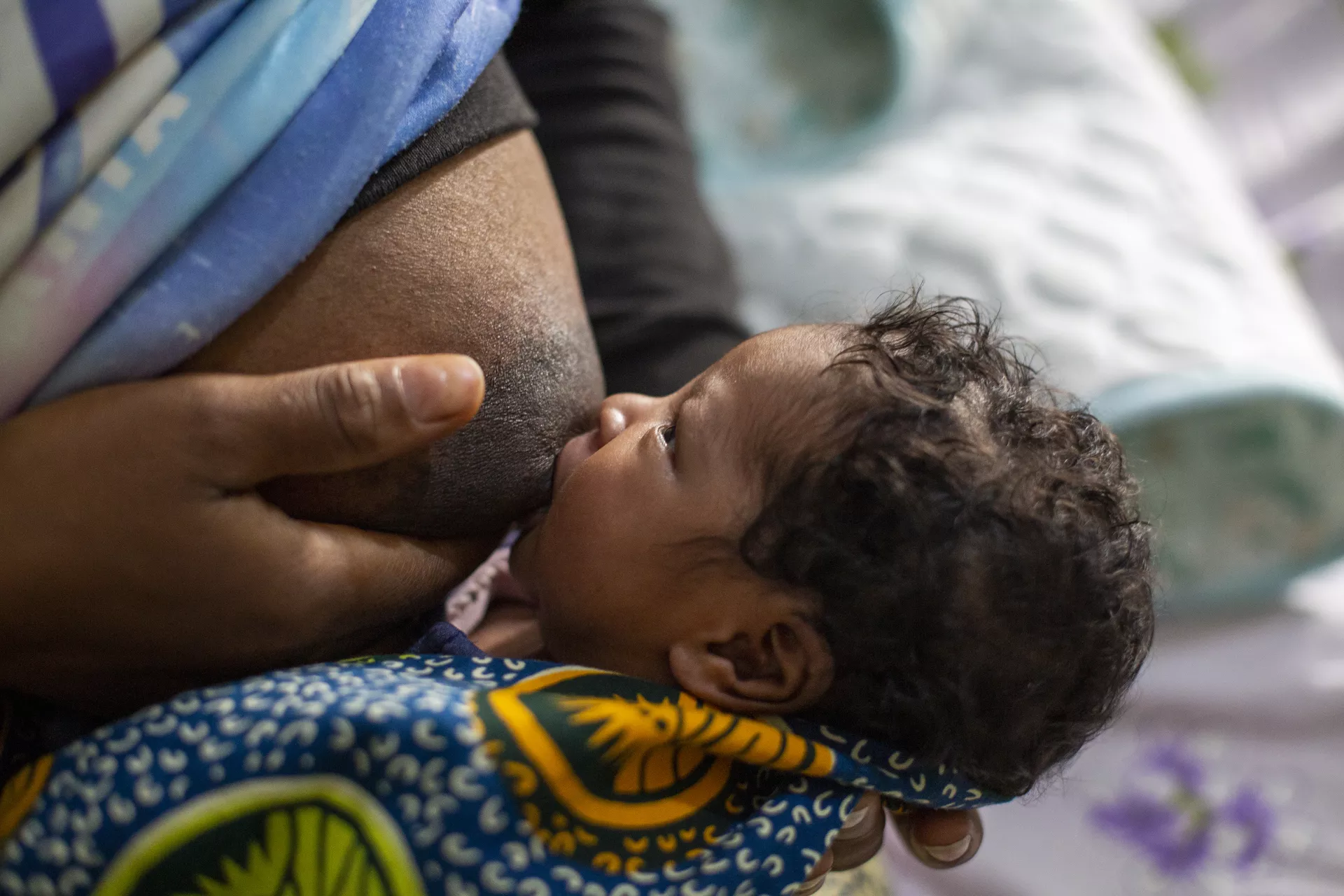 Mcumuna Balde ( 25) feed her newborn baby girl 