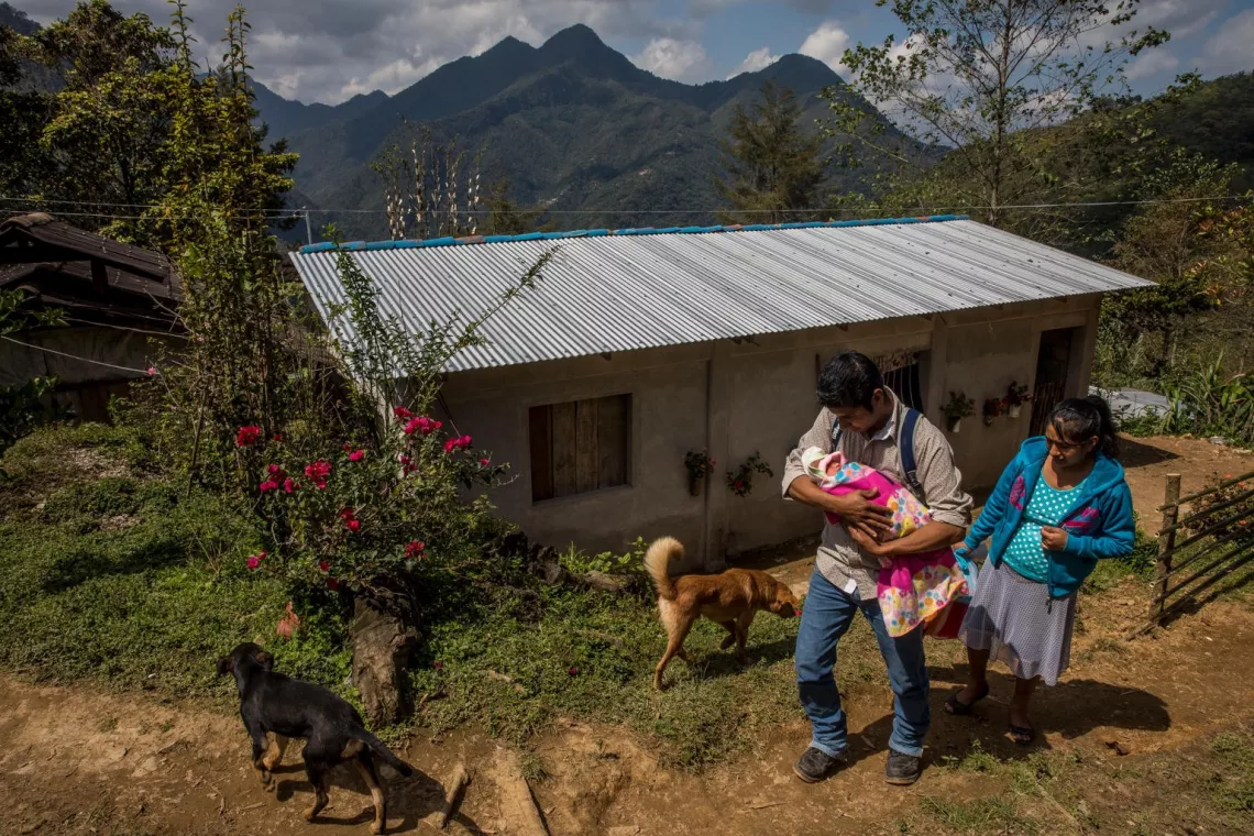Parents climb the hill back to their home