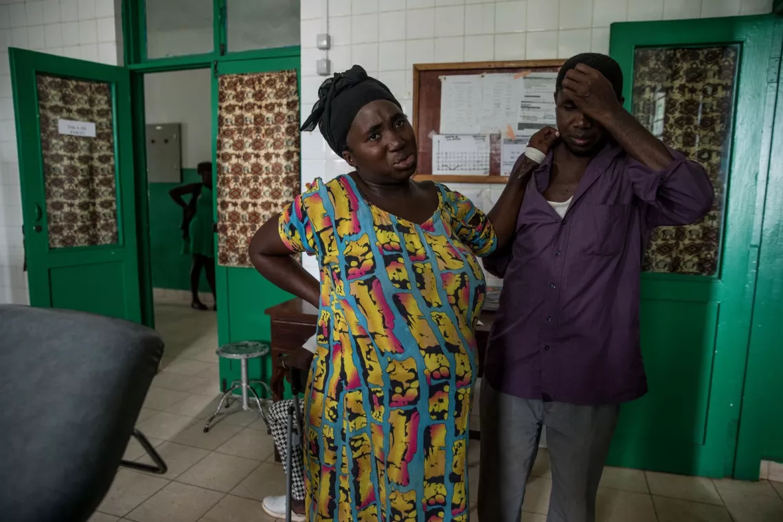 Pregnant lady in pain leans towards husband for support