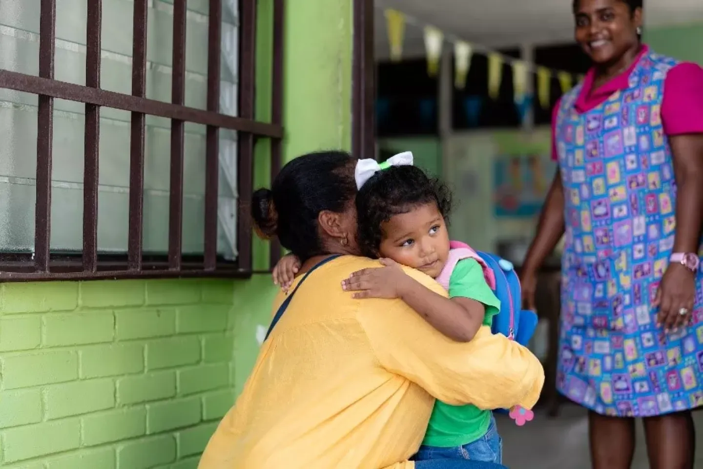 Three year old Sheria shares a warm hug with her aunt at morning drop-off, a sweet moment of comfort and connection as she begins her day at daycare.