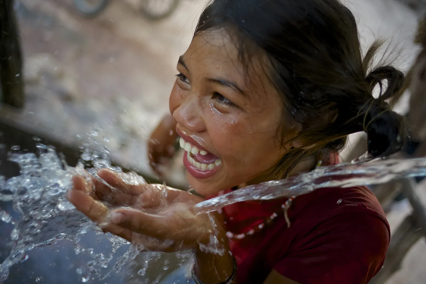 Girl smiles while drinking water