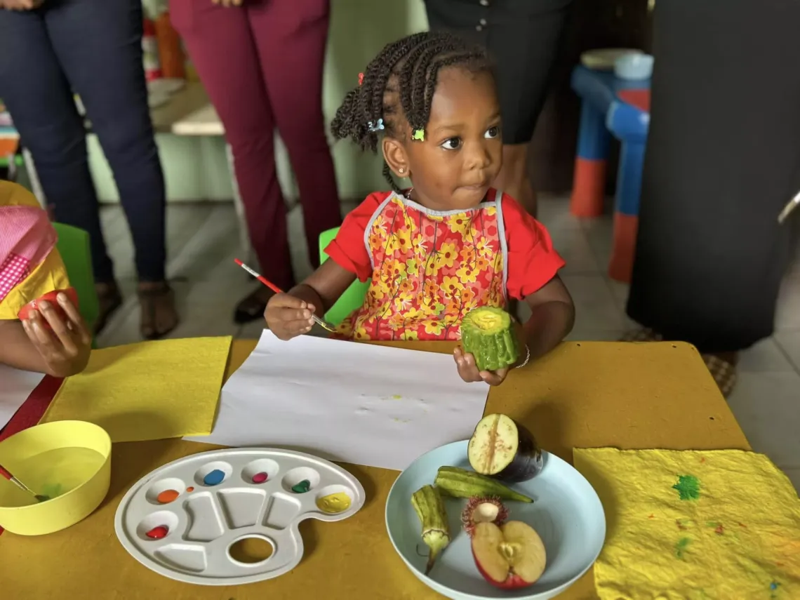 Girl participates in painting exercise at UNICEF Early Learning handover event