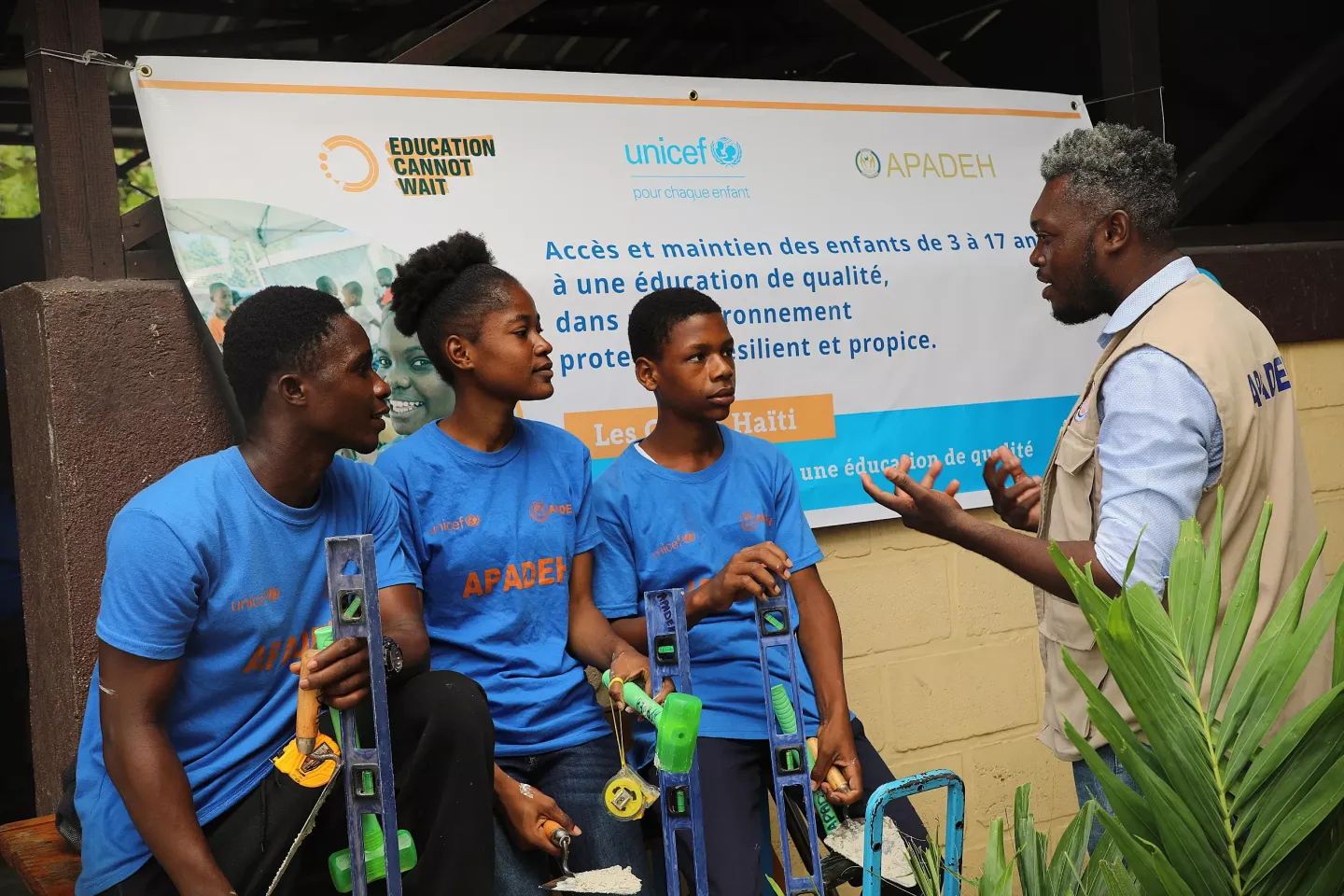 A man talking with 3 young people
